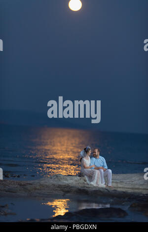 Bride and groom under the full moon, Bride and groom under the moon light, most romantic wedding photo Stock Photo