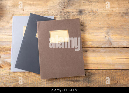 School notebooks stack, old fashioned, isolated on wooden background, blank label, copy space, top view Stock Photo