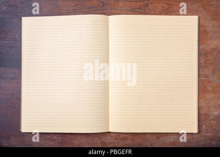 Open blank school notebook or diary, old fashioned, isolated on wooden desk, space for text, top view Stock Photo