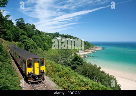 The Train to St Ives, Cornwall passes the beach of Carbis Bay, the location of the 2021 G7 Summit. Stock Photo
