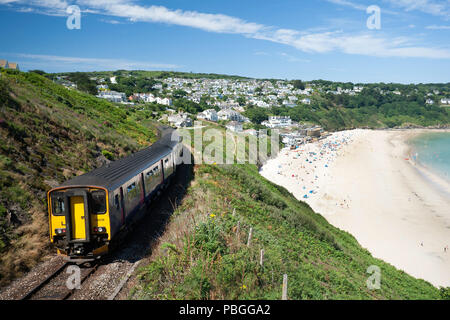 A train to the Cornish coast and seaside town of St Ives, seen here at Carbis Bay the location of the 2021 G& Summit. Stock Photo