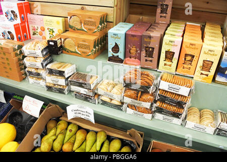 Packets of biscuits for sale in a country farm shop, Morcombelake, Dorset, UK - John Gollop Stock Photo