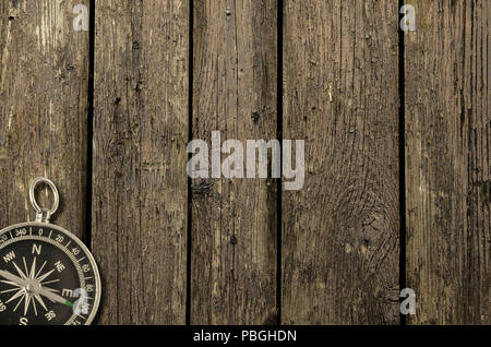 Compass on an old wooden background. Adventure and travel concept. Copy space Stock Photo