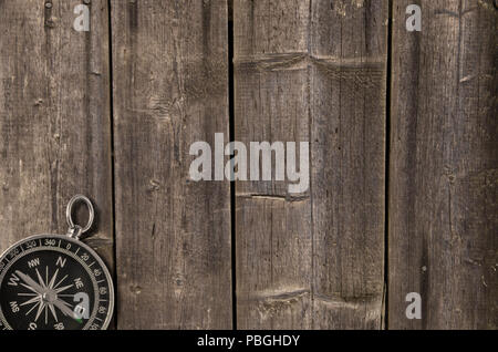 Compass on an old wooden background. Adventure and travel concept. Copy space Stock Photo