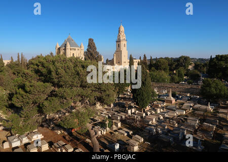 View of the Conical dome and bell tower of the Church of the Benedictine Abbey of the Dormition across the Protestant Mount Zion Cemetery established by Presbyterian missionaries in the 19th-century located on the southwestern slope of Mount Zion in Jerusalem Israel Stock Photo