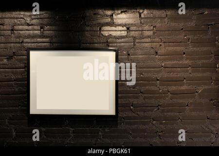 empty black wooden picture frame on brick wall Stock Photo