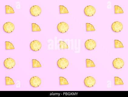 Pineapples on pink background. Pattern made of sliced pineapples. top view minimal Stock Photo