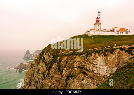 The lighthouse of Roca's Cape and the cliffs on the Atlantic ocean in Portugal Stock Photo