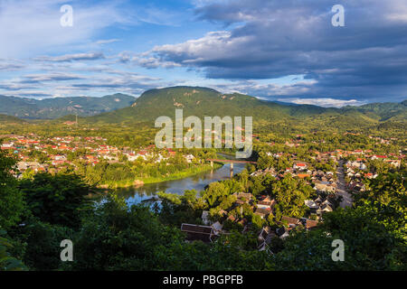 View of Luang Prabang and Nam Khan river in Laos with beautiful sunset light bathing the city Stock Photo