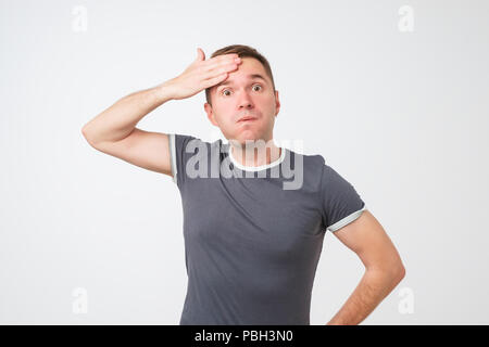 Exhausted european man wipes the sweat of his forehead. Stock Photo