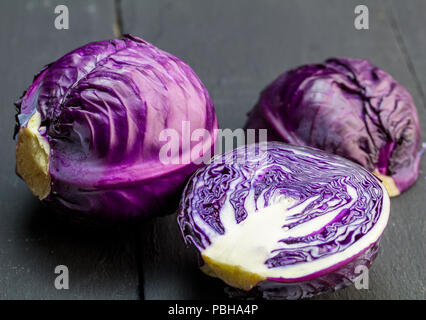 Purple cabbage isolated on rustic black wooden background closeup Stock Photo