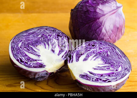 Purple cabbage isolated on wooden table close up Stock Photo