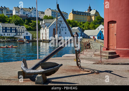 lighthouse and anchor at entrance of old harbor, Ålesund, Norway, Europe Stock Photo