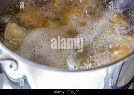Pan of potatoes cooking in boiling water Stock Photo