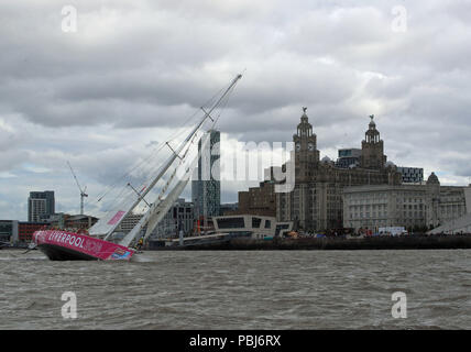 The Liverpool 2018 team arrives at the finish line after a &quot;sprint finish&quot; to conclude the Clipper 2017-2018 Round the World Yacht Race outside the Royal Albert Dock in Liverpool. Stock Photo