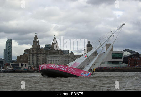 The Liverpool 2018 team arrives at the finish line after a &quot;sprint finish&quot; to conclude the Clipper 2017-2018 Round the World Yacht Race outside the Royal Albert Dock in Liverpool. Stock Photo