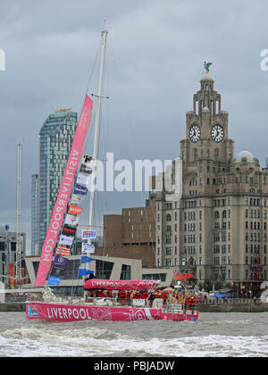 The Liverpool 2018 team arrives at the finish line after a 'sprint finish' to conclude the Clipper 2017-2018 Round the World Yacht Race outside the Royal Albert Dock in Liverpool. Stock Photo