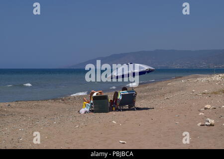 Couple resting on the beach in Cyprus Stock Photo
