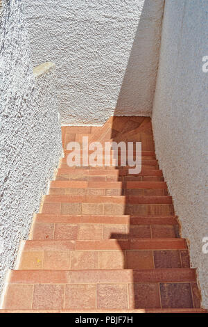 Outdoors Tiled staircase and textured wall from above Stock Photo