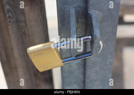 A padlock on metal door on the door in a park. Stock Photo