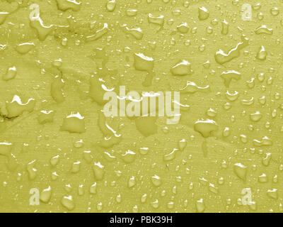 water drops on limelight colored metallic surface Stock Photo