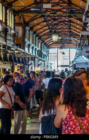 MADRID, SPAIN - AUGUST 27, 2017: People visiting and enjoying drinks and tapas inside the historical 'Mercado de San Miguel' (Market of San Miguel) Stock Photo