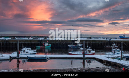 Helmsdale, Scotland, UK - December 3, 2010: Boats are moored in the harbour at Helmsdale on the Moray Firth coast of the Highlands of Scotland at suns Stock Photo