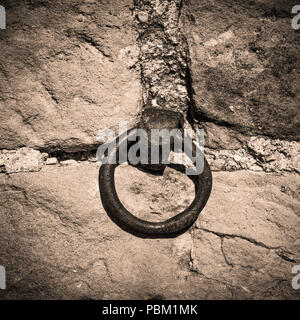 Old iron ring in a rustic wall Stock Photo