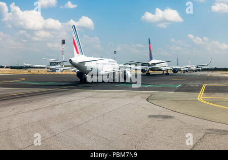 Row of Four airplanes waiting to take of at runway, airport Charles de Gaulle, Paris, France. Stock Photo