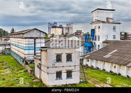 Vitebsk, Belarus - July 7, 2018: view of an old brick building, Belarusian granaries and machine for sowing grain. Stock Photo