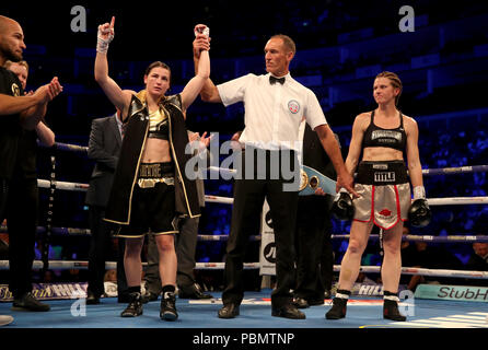 Katie Taylor (left) celebrates beating Kimberly Connor during their IBF and WBA World Female Lightweight Title bout at the O2 Arena, London. Stock Photo