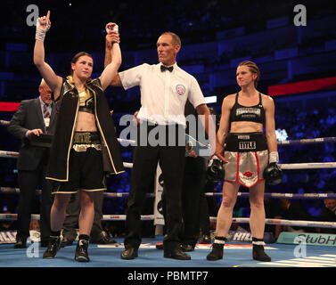 Katie Taylor (left) celebrates beating Kimberly Connor during their IBF and WBA World Female Lightweight Title bout at the O2 Arena, London. Stock Photo