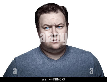 Close-up portrait of white Caucasian big fat stout man with blue eyes looking directly in camera in studio on light background, sceptical suspicious e Stock Photo