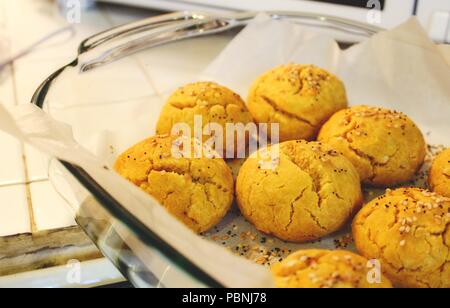 Sweet potato and pumpkin bread rolls freshly baked in a pyrex dish Stock Photo