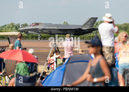 A Lockheed Martin F-35 Lightning II taxiing on the runway at RIAT Fairford 2018, UK, with spectators looking on. Stock Photo