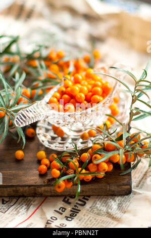 sea buckthorn berries are fresh and a branch with leaves. Vintage photo. Vitamins and health Stock Photo