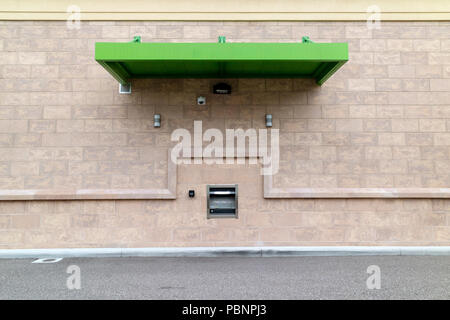 Hole in the wall. Cash machine drive through. An American bank premises. Stock Photo