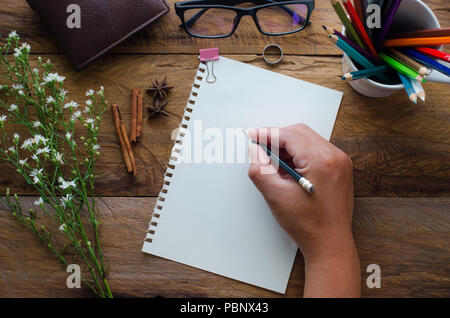 Hand-written note on a wooden table. Stock Photo