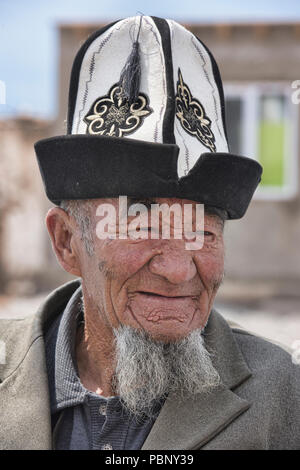 Man with kalpak hat in the bazaar, Sary Mogul, Kyrgyzstan Stock Photo