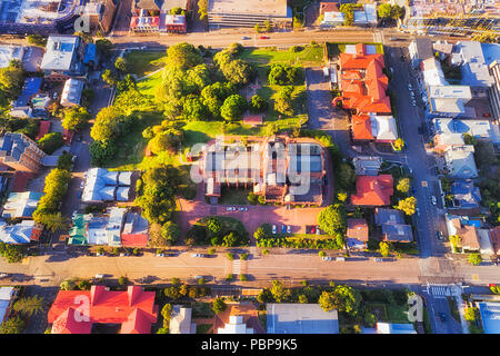 Local architectural historic landmark in modern city Newcastle of Australia. Aerial overhead view down to Cathedral site, roof and local park surround Stock Photo