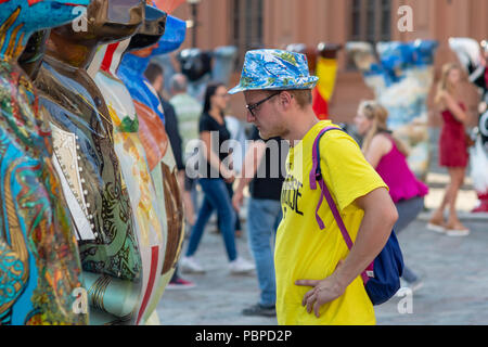 RIGA, LATVIA - JULY 26, 2018: United Buddy Bears exhibition. City residents and tourists are looking at and photographing the exhibition at the Old To Stock Photo