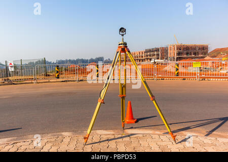 Surveying tripod on construction site with blue sky background Stock ...