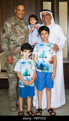 U.S. Army Lt. Gen. Michael X. Garrett, U.S. Army Central commanding general and Lt. Col. Ali Al-Shamsi, Land Forces Institute commander, pose for a photo with members of Lt. Col. Al Shamsi's family in Abu Dhabi, United Arab Emirates, July 23, 2018. Creating and maintaining relationships is an important part of building trust and enhancing collaboration with partner nations. (U.S. Army photo by Staff Sgt. Andrew S. Carroll) Stock Photo