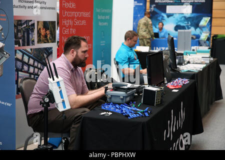 U.S. Army Garrison Wiesbaden is a United States Army installation in Germany supporting U.S. Army Europe headquarters. An exhibitor representing Cisco Systems worked on computer equipment during the Tech Expo held July 26, 2018, in Wiesbaden, Germany. The archival image documents industry participation in Army network technology events. Stock Photo