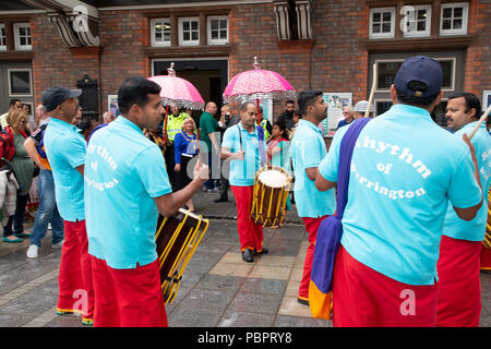 Warrington, UK, 29 July 2018.   Warrington Ethnic Communities Association (WECA) held its fifth annual MELA Festival. The usual walk from The Town Hall did not take place due to the wet and windy weather and the event that should have been held in the Queen’s Gardens at Palmyra Square, close to the Town Centre, was changed to inside the Parr Hall building Stock Photo