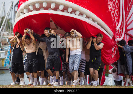 Minamichita, aichi, Japan. 29th July, 2018. Participants seen moving a sea bream figure during the festival.The sea bream or tai maturi festival is a traditional festival in Minamichita, Aichi, Japan. It's also called the strange festival or unusual festival, a float of bream is carried by young people who walk around town and the sea. Its purpose is to pray for marine safety and good catch. Credit: Takahiro Yoshida/SOPA Images/ZUMA Wire/Alamy Live News Stock Photo