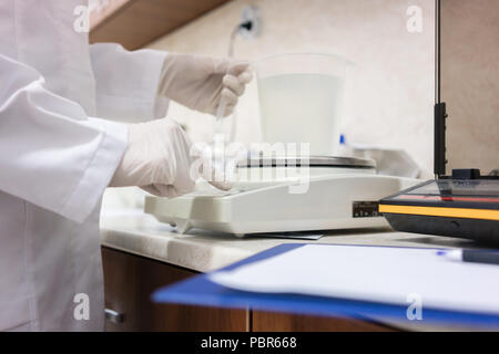 Close-up of the hands of an expert analyzing sample in the laboratory Stock Photo