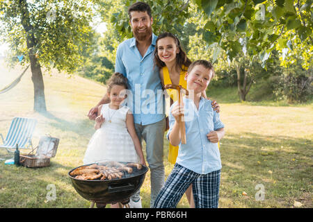 Portrait of happy family with two children standing outdoors Stock Photo