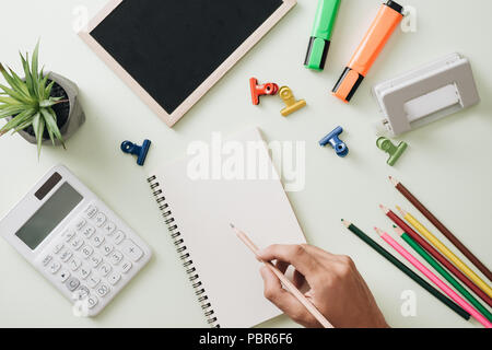 Office workplace - empty notepad, pen, pencil, ruler, compass on dark wooden background Stock Photo