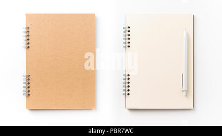 Design concept - Top view of kraft spiral notebook, blank page and pen isolated on white background for mockup Stock Photo